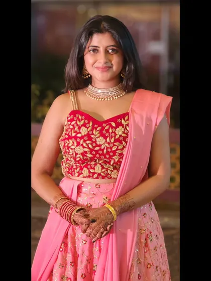 A full shot of the pink and red lehenga, perfect for dancing the night away at a sangeet.