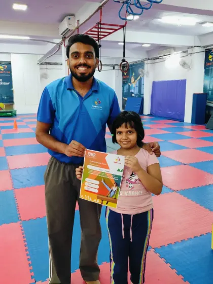 This student is happy to be recognized for her progress with a new certificate.