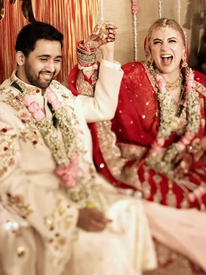 A moment of pure, uninhibited joy from a cross-cultural couple after their wedding ceremony. This is the kind of authentic happiness we love to capture.