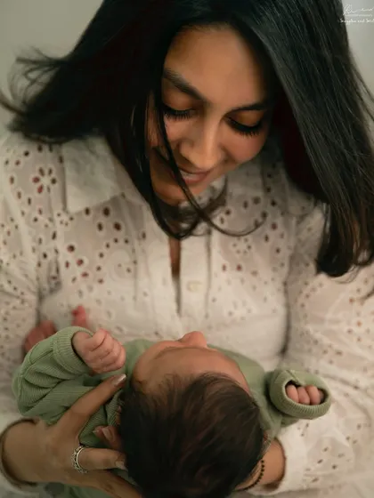 A mother holding her newborn close, her expression full of love. These are the quiet, authentic moments I strive to capture.