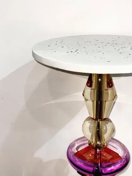 A sneak peek of a new accent table, combining a minimal blue terrazzo top with a colorful, sculptural acrylic base. This piece is all about mixing materials and playful design.