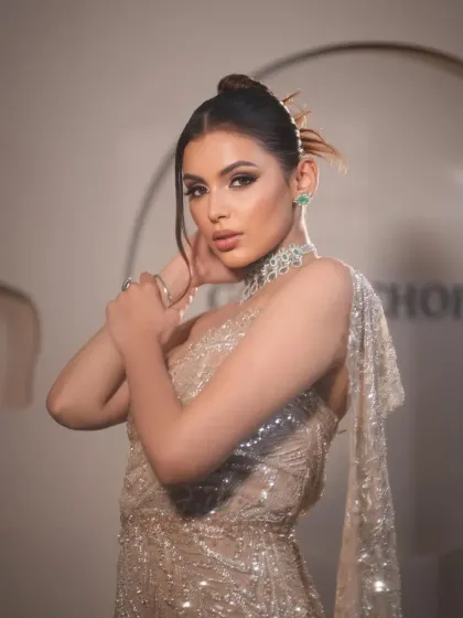 A confident pose that highlights the modern silhouette and the sparkling details of this glamorous gown.