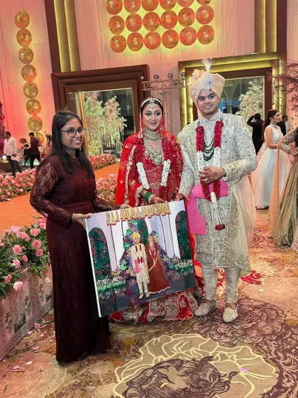 Presenting the finished canvas to the bride and groom in Gurugram. It's a moment of pure happiness and a wonderful photo opportunity for the couple.