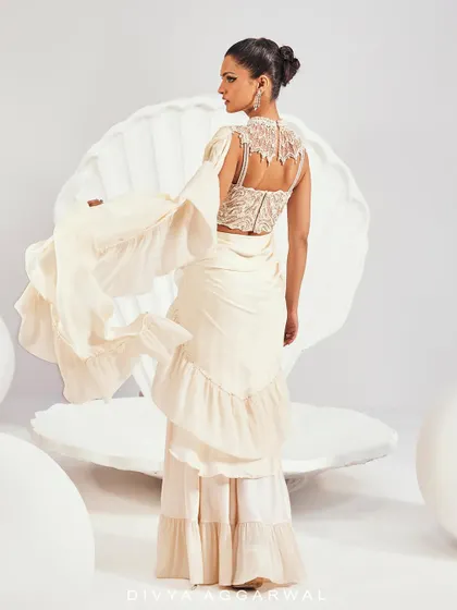 The back view of our Kairi Saree Set, featuring a high-neck embellished blouse and a dramatic ruffled drape.
