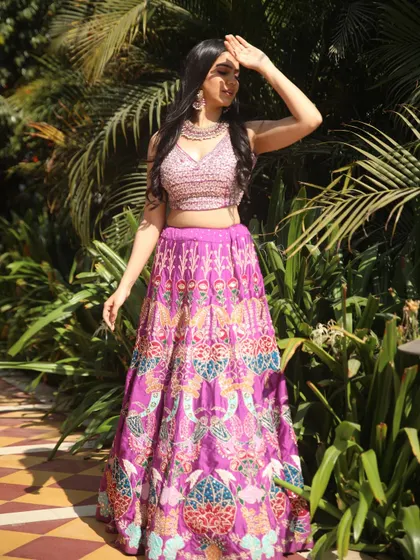 A full-length shot of the purple lehenga, showing off its vibrant patterns and my confident stance.