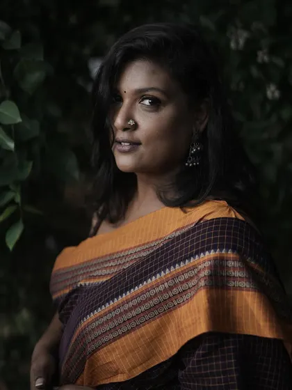 A quiet, pensive moment during a photoshoot. I'm wearing a beautiful handloom saree that feels like an extension of my soul.