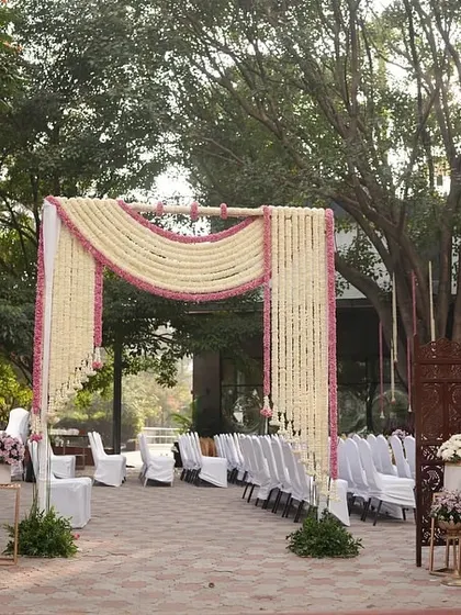A wide view of the floral archway, creating an elegant entrance for an outdoor ceremony.