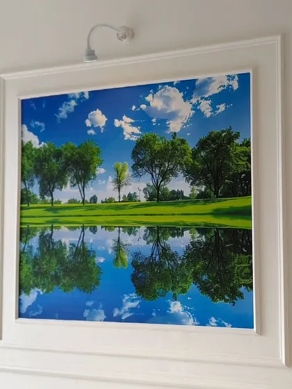 Another example of a framed wallpaper installation, creating a window-like view with a beautiful lake reflection scene.
