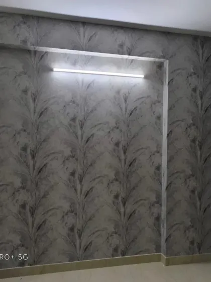 A grey wallpaper with a vertical leaf stalk pattern. The textured look adds depth and sophistication.