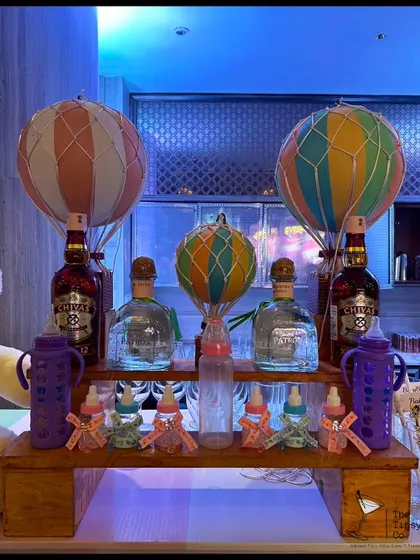 Another creative baby shower theme, this time with hot air balloons over the liquor bottles. It shows our ability to adapt to any occasion, making even the drinks part of the decor.