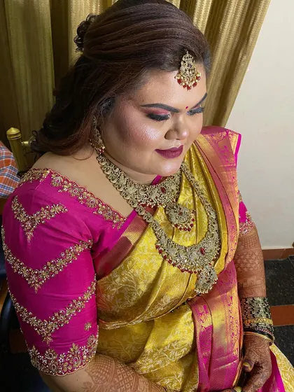 A reception look featuring a half-updo with soft curls, perfect for a client who wants an elegant and comfortable style.