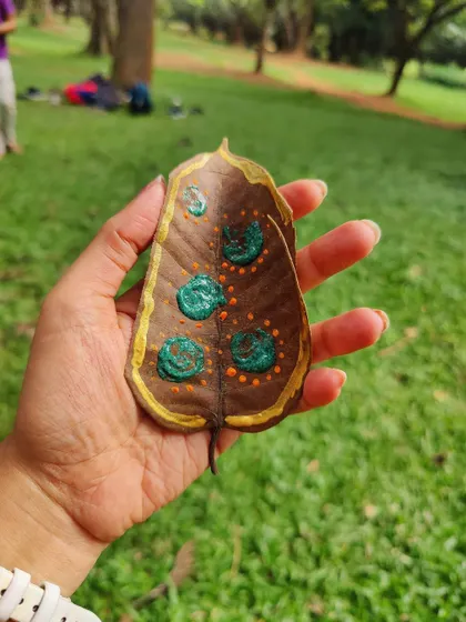 A close-up of a painted leaf, a beautiful example of the nature-based art we create in our park sessions.