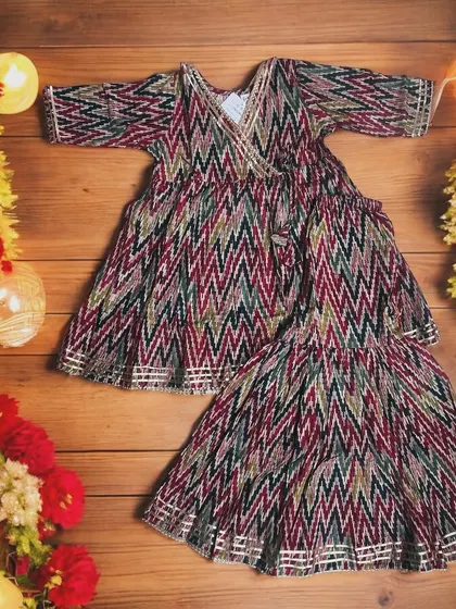 Diwali Ready in Style! This festive season, dress your little one in our vibrant cotton Angarkha set with playful zig-zag patterns and chic sharara bottoms.