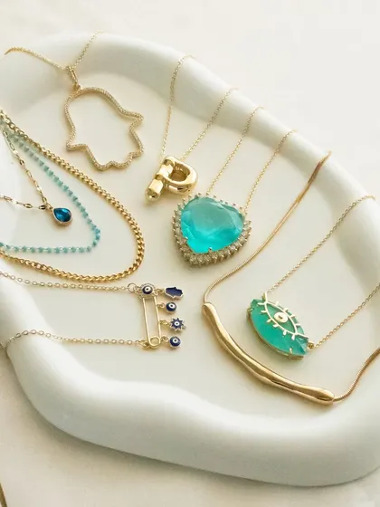 Good vibes only. This tray showcases some of my most popular necklaces, including the turquoise heart, jumbo hamsa, and various evil eye designs.