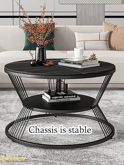 This round coffee table features a striking hourglass-shaped wireframe base in black metal. The two-tiered design provides ample storage, while the black wood-finish top adds a touch of modern sophistication.