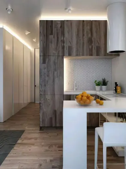 This design shows how a small peninsula can create a functional breakfast nook in a compact apartment, seamlessly connecting the kitchen to the living area.