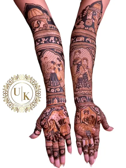 I love the challenge of creating detailed, multi-figure portraits in my mehandi designs. This piece shows different scenes and people, telling a rich story on the bride's arms.