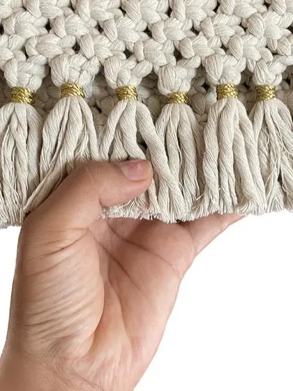 I love adding little details, like these tiny golden threads wrapped around the tassels of my off-white clutch. It just gives it a little something extra.