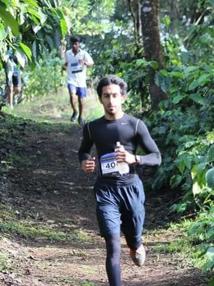 Running on a trail through the woods. This kind of terrain is more challenging but also more rewarding than road running.