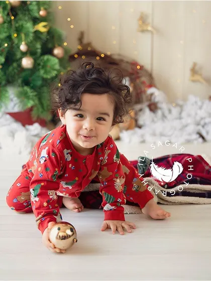 A sweet and curious expression from a baby boy during his Christmas-themed photo shoot.