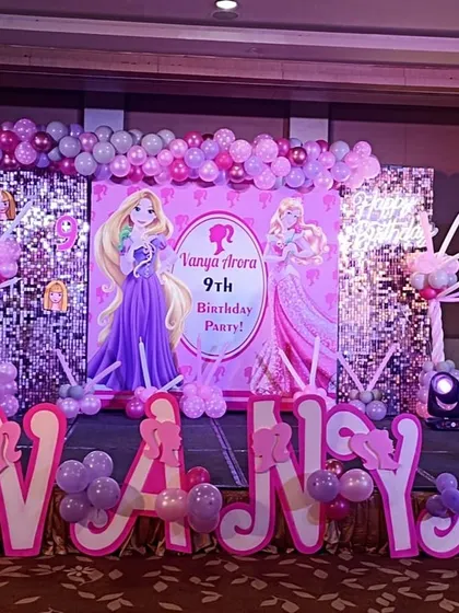 A Barbie and Rapunzel theme party fit for a princess. I designed this grand stage with a sequin wall, large character cutouts, custom name lettering, and a pink and purple balloon arrangement for Vanya's 9th birthday.