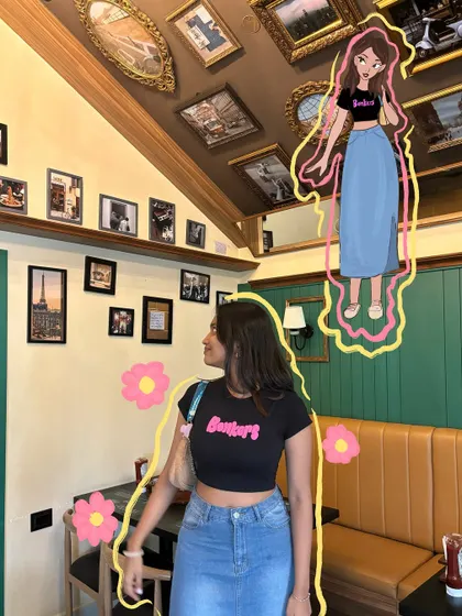 A casual cafe look with a denim skirt, brought to life with a floating cartoon illustration and floral doodles.