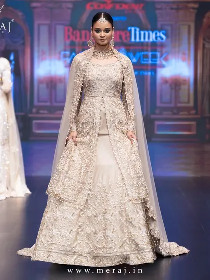 A full runway view of the Gold Tail Peplum Indo-Western, with its regal tail flowing behind, defining timeless glamour.