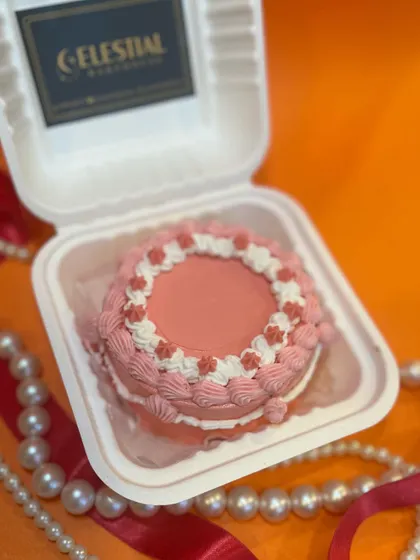 A vintage-style pink bento cake with intricate piping, perfect for an elegant and intimate celebration for two.
