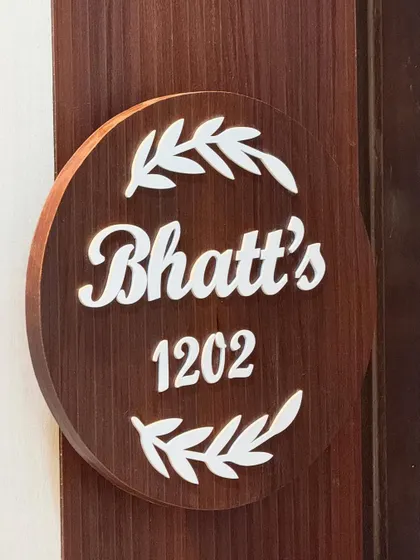 A custom wooden nameplate for the "Bhatt's" residence. Personal touches like these are part of my turnkey service, ensuring every detail of the entrance is considered.
