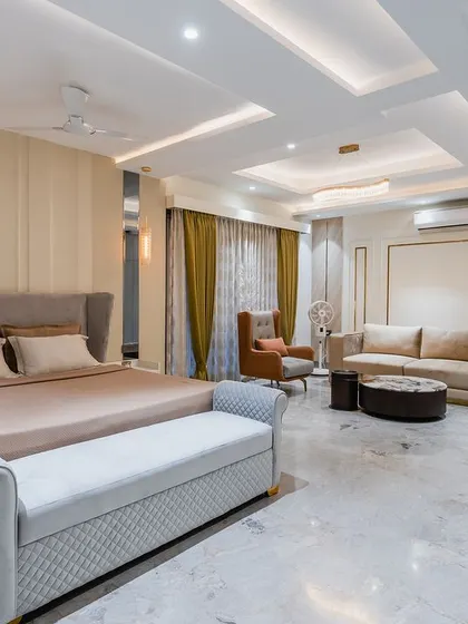 A full view of the expansive master bedroom, showing how the sleeping and seating areas are distinct yet harmonious. This is a true retreat.