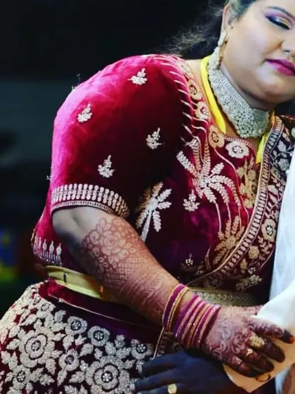 A touching moment between a bride and groom, where you can see a glimpse of the beautiful bridal mehendi I created for her.