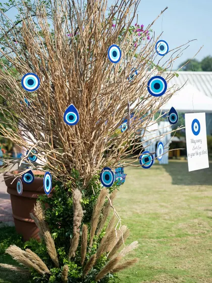 An "Evil Eye" tree, a unique and spiritual decor element where guests can hang protective talismans for the couple.