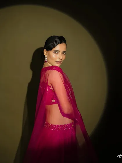 A more dramatic, moody shot. The makeup transitions well from bright to low light, maintaining its elegance and definition.
