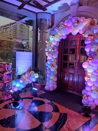 An inviting entrance arch made of pastel balloons in purple, pink, and yellow. This sets a cheerful tone for the baby shower right from the moment guests arrive.
