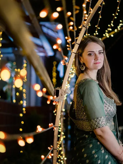 A solo portrait of the bride against a backdrop of beautiful bokeh lights.