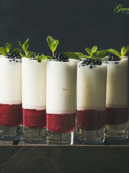 A healthy and elegant dessert or breakfast option. We layer Greek yogurt with a fresh strawberry coulis and top it with blackberries and mint, served in tall shot glasses for a modern look.