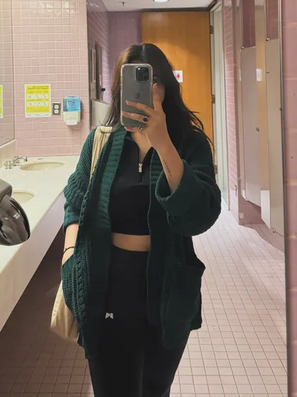 A mirror selfie in a cozy green cardigan, part of a college life photo dump.