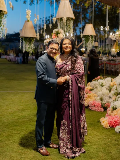 The parents of the bride, looking elegant and proud in their custom-styled reception attire.