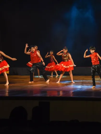 A full stage view of the kids' performance, showing how they command the space even at a young age.