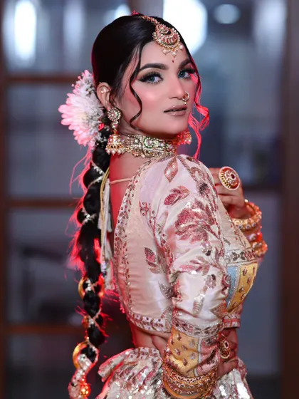 A side profile showing the beautiful braided hairstyle with a traditional parandi. A perfect fusion of modern and traditional.