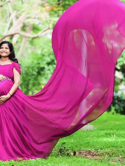 The long trail of this magenta maternity gown in action. I design these gowns to be photogenic from every angle, ensuring you get those epic, memorable shots.