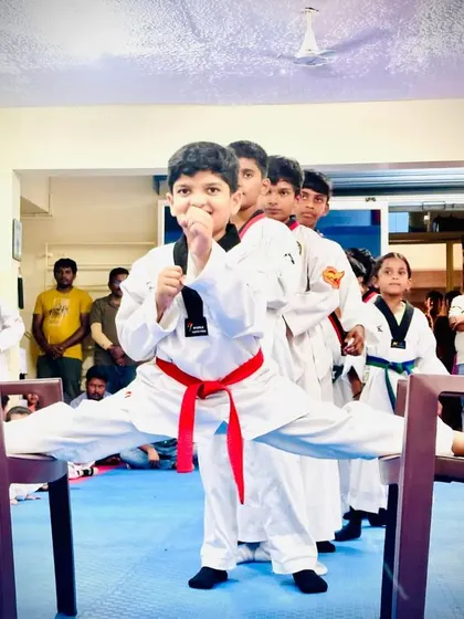 A student shows off his impressive chair split.