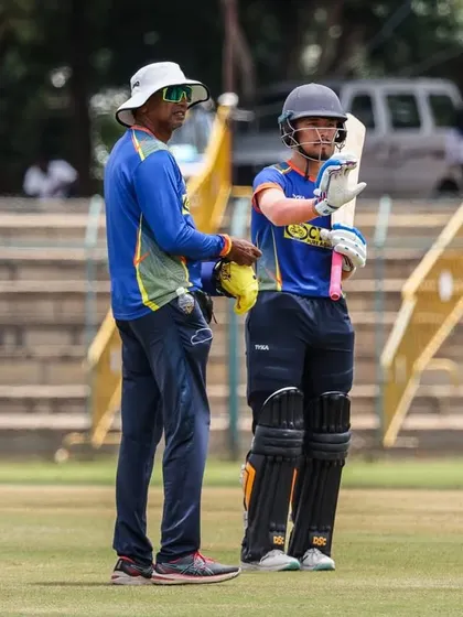 Giving some pointers to a batsman during a practice session. Small adjustments can make a big difference.