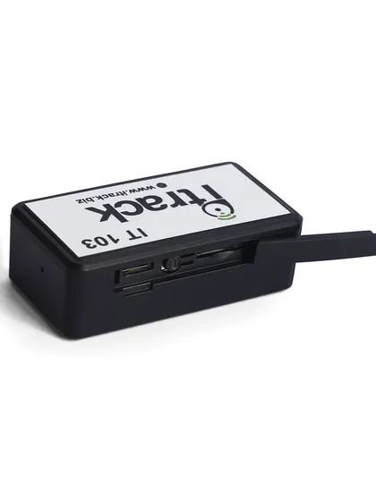 A shot of the GPS tracker with its side port cover open, revealing the internal slots. This functional detail is vital for customer understanding.