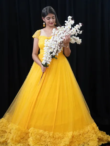Another angle of our yellow ruffle gown, a client favorite for its vibrant color and beautiful design.