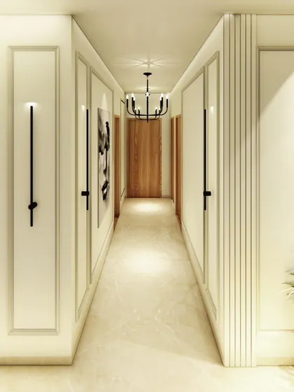 A beautifully designed hallway with classic wall molding and modern, minimalist wall sconces. The design turns a simple corridor into an elegant gallery-like space.