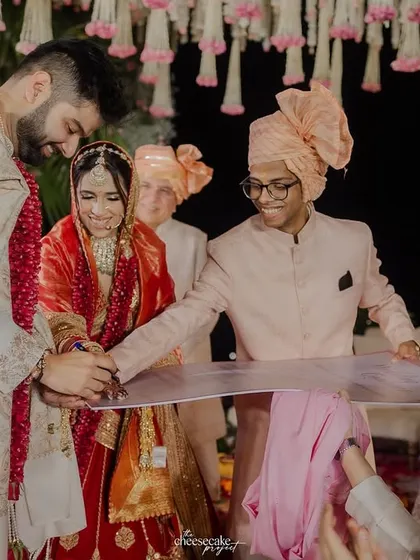 Another angle of the wedding contract signing, showing the happy involvement of their friends.