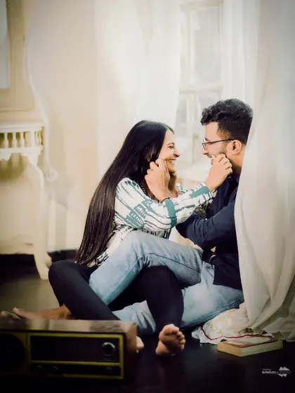 A cozy and playful indoor moment. Sitting on the floor, surrounded by soft curtains, this shot captures the simple, everyday love that is so special.