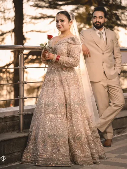 A full-length portrait of the couple during sunset. The bride's stunning gown catches the light beautifully.