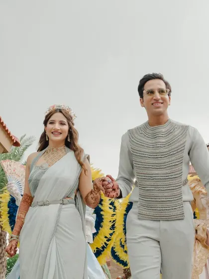 The couple making their entrance, hand in hand, looking happy and ready to celebrate.